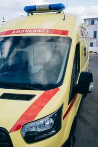 A yellow ambulance vehicle parked in an urban area, showcasing emergency readiness.